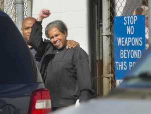 Albert Woodfox, right, raises a clenched fist as he walks out of the West Feliciana Detention Center with his brother, Michael Mable, left, Friday, Feb. 19, 2016, in St. Francisville, La. Woodfox was released Friday after pleading no contest to manslaughter and aggravated burglary in the 1972 death of a prison guard. Woodfox and two other men became known as the "Angola Three" for their decades-long stays in isolation at the Louisiana Penitentiary at Angola and other state prisons. (Travis Spradling/The Advocate via AP) MAGS OUT; INTERNET OUT; NO SALES; TV OUT; NO FORNS; LOUISIANA BUSINESS INC. OUT (INCLUDING GREATER BATON ROUGE BUSINESS REPORT, 225, 10/12, INREGISTER, LBI CUSTOM); MANDATORY CREDIT