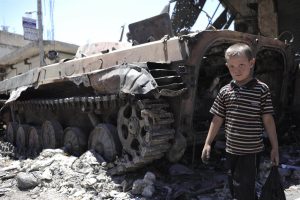 [THIS IMAGE IS FOR USE BY UNICEF ONLY DO NOT SHARE WITH EXTERNAL MEDIA] On 3 July, a boy walks by a destroyed armoured personnel carrier, surrounded by rubble, in a town affected by the conflict. By July 2012 in Syria, escalating conflict between rebel and government forces is taking an increasing toll on children and their families. Deaths, including of children and women, have surpassed 17,000, and an estimated 1.5 million people inside Syria are in need of humanitarian assistance. Education and health services have been disrupted, and food insecurity is rising. Up to 1 million people have been internally displaced, with an increasing number being displaced for a second time as the conflict continues to spread. Over 120,000 refugees half of them children have fled to neighbouring Iraq, Jordan, Lebanon and Turkey. UNICEF is working with diverse governments, the United Nations High Commission for Refugees (UNHCR) and local and international NGOs to respond to the needs of affected children, both in and outside the country. UNICEF supports initiatives in education, water, sanitation and hygiene and child protection, including psychosocial assistance for children traumatized by the conflict to which they have been subjected or borne witness. UNICEF has requested US$39.2 million to fund this work, of which only 30 per cent has been received to date.